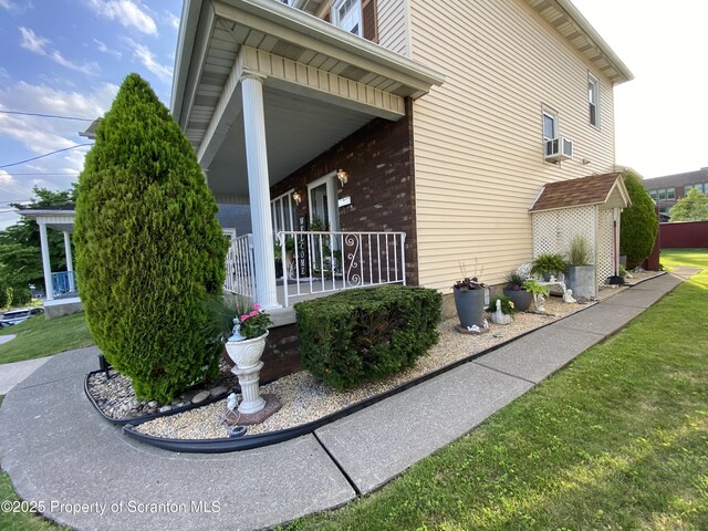906 Cedar Ave, Scranton, PA 18505 - view of side of home with a porch, a lawn, and brick siding