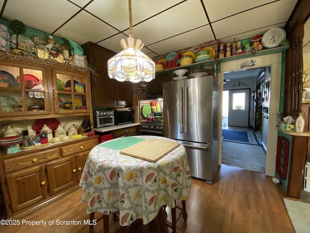906 Cedar Ave, Scranton, PA 18505 - kitchen with freestanding refrigerator, light wood finished floors, a drop ceiling, glass insert cabinets, and light countertops