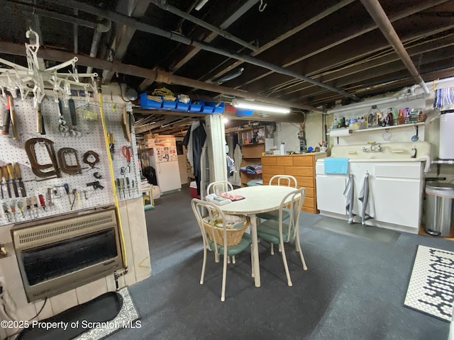 906 Cedar Ave, Scranton, PA 18505 - unfinished basement featuring heating unit, freestanding refrigerator, and a workshop area