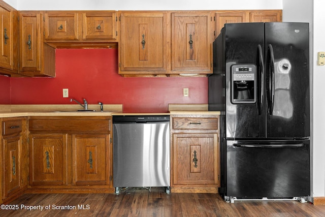 kitchen featuring a sink, black refrigerator with ice dispenser, dishwasher, and light countertops