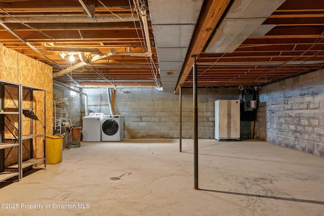 unfinished basement featuring independent washer and dryer