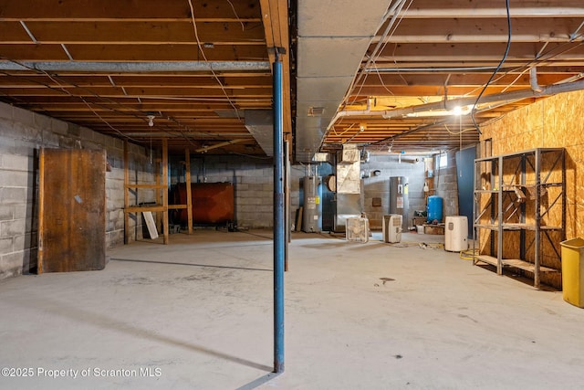 unfinished basement featuring heating fuel and water heater