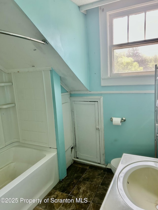 full bath featuring vanity and stone finish floors