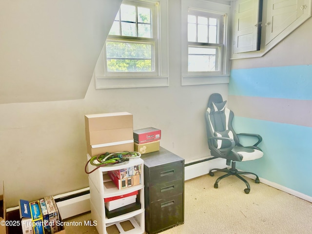 carpeted office space with a baseboard radiator and vaulted ceiling