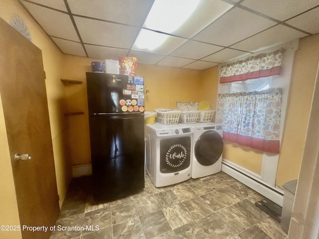 laundry area with a baseboard radiator and washer and clothes dryer