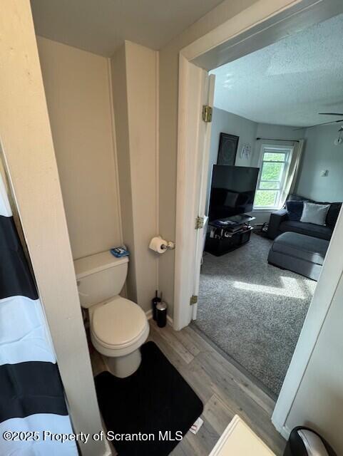1449 Dickens St, Scranton, PA 18504 - bathroom featuring toilet, wood finished floors, and a ceiling fan
