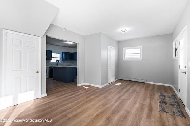 interior space with hardwood / wood-style floors and a baseboard radiator