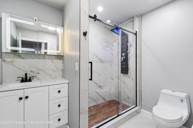 bathroom with toilet, a shower with door, decorative backsplash, and vanity