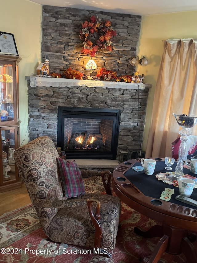 sitting room featuring a fireplace and hardwood / wood-style flooring