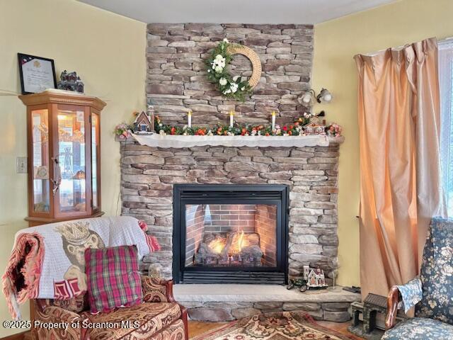 interior details with a stone fireplace