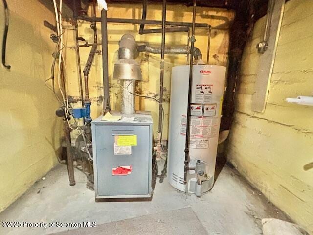 utility room with gas water heater and a heating unit