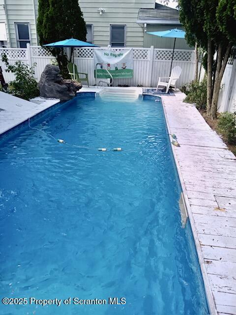 view of pool with fence and a fenced in pool