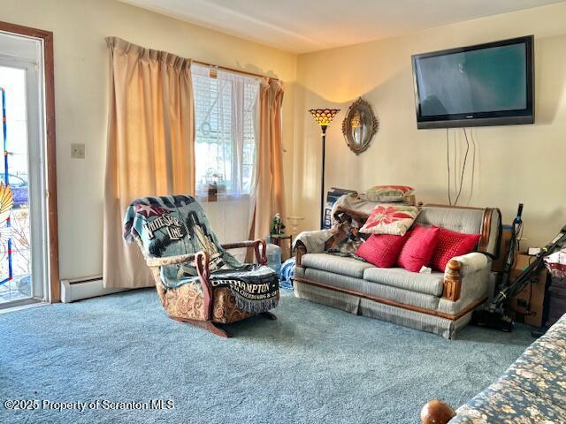 sitting room featuring carpet and a baseboard heating unit