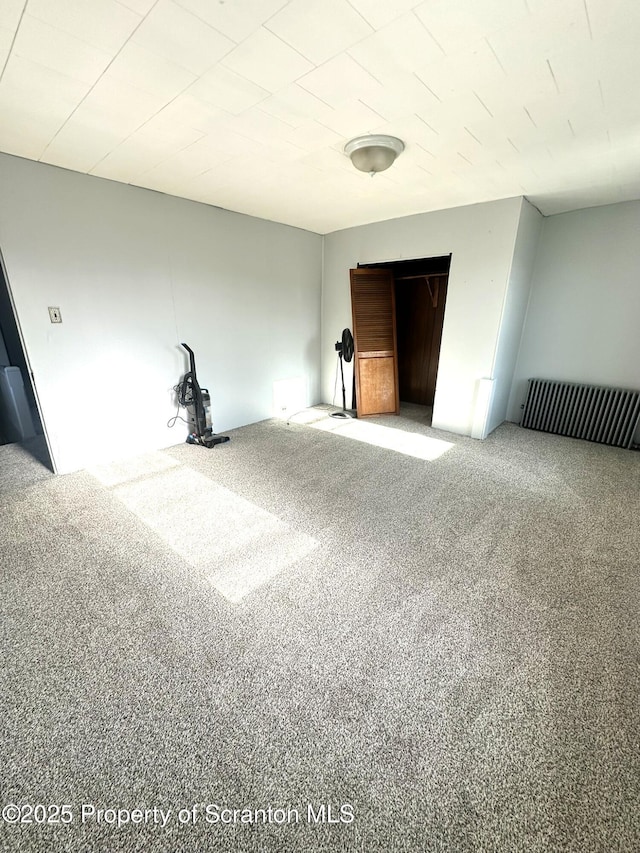 unfurnished bedroom featuring carpet and visible vents