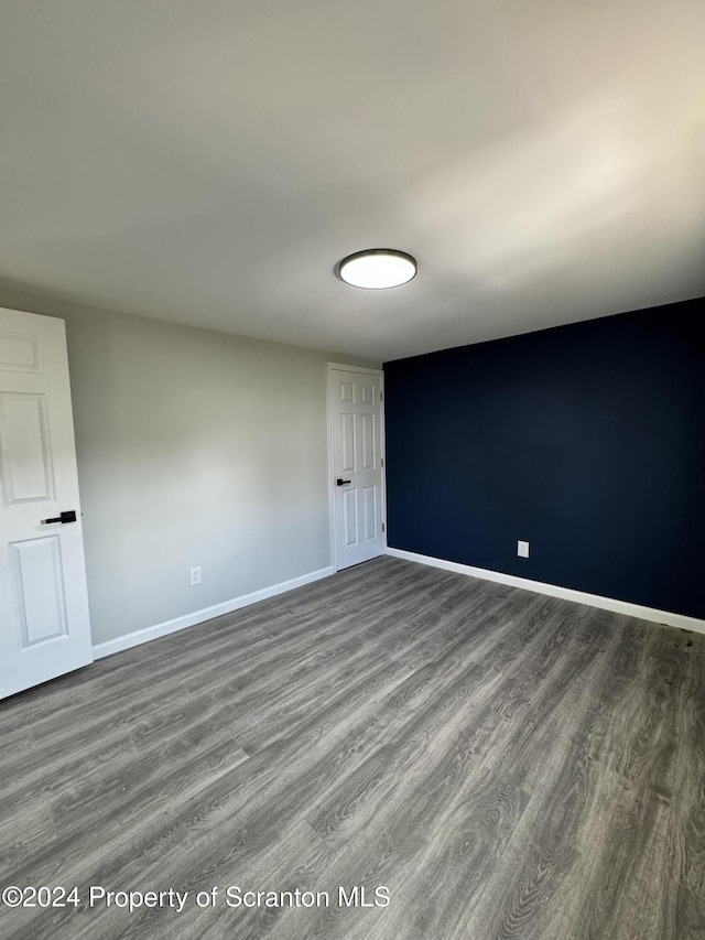 unfurnished room featuring hardwood / wood-style flooring