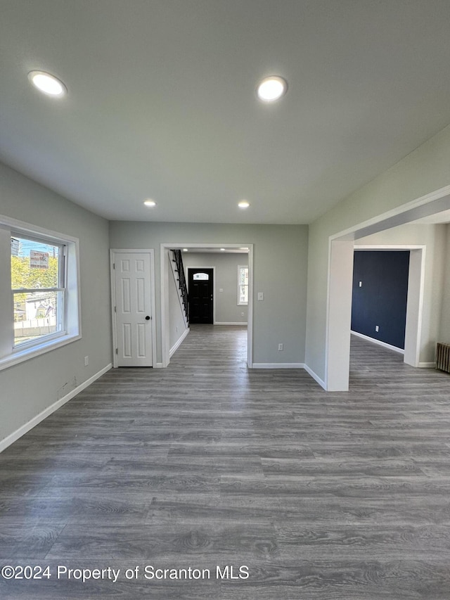 unfurnished living room featuring dark hardwood / wood-style floors