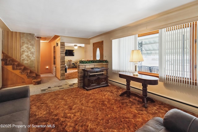 living room with baseboard heating and carpet