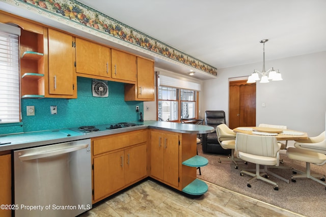 kitchen with kitchen peninsula, dishwasher, decorative light fixtures, white gas stovetop, and an inviting chandelier