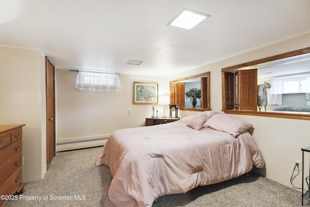 bedroom featuring baseboard heating and light carpet