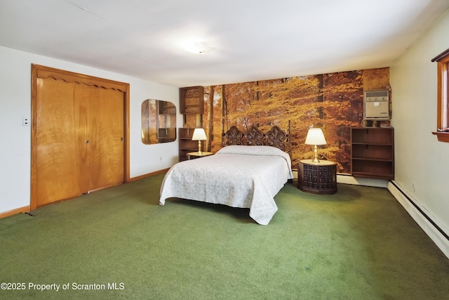 bedroom with an AC wall unit, dark carpet, and a baseboard heating unit