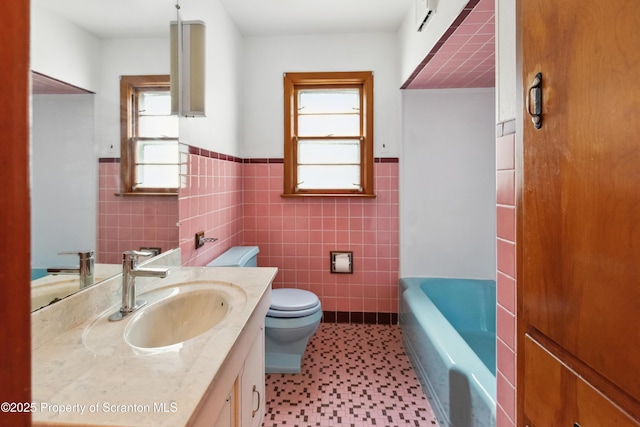 bathroom featuring a washtub, tile walls, and a healthy amount of sunlight