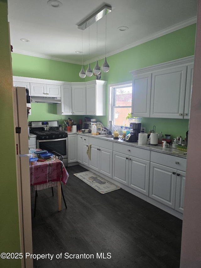 kitchen featuring white cabinetry, decorative light fixtures, ornamental molding, and gas stove