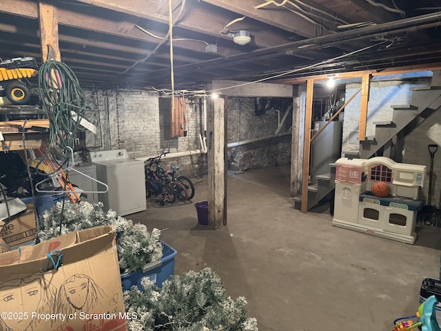 basement featuring washing machine and dryer and gas water heater