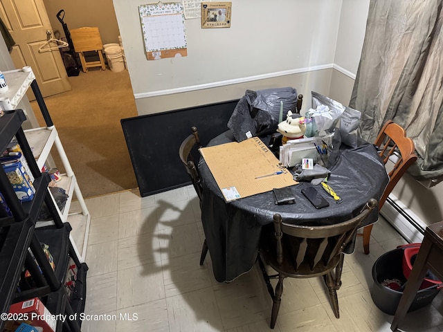 dining area with a baseboard heating unit