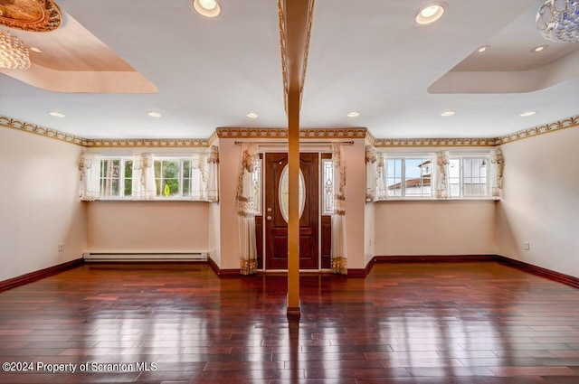 foyer entrance featuring dark hardwood / wood-style flooring and baseboard heating