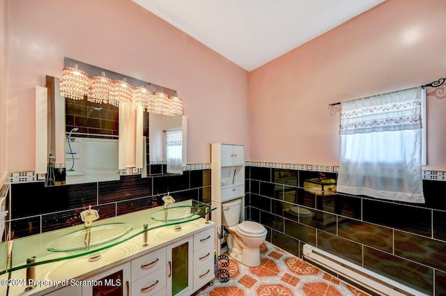 bathroom featuring vanity, an inviting chandelier, tile patterned flooring, tile walls, and a baseboard radiator