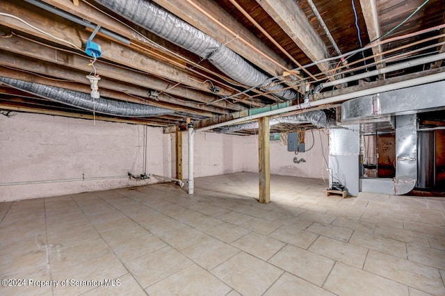 basement with electric panel and heating unit