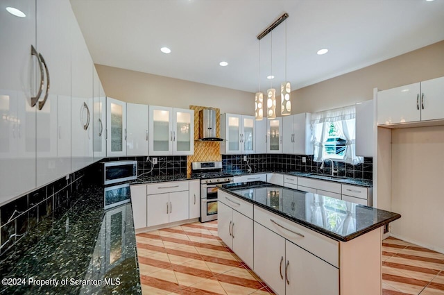 kitchen featuring pendant lighting, a kitchen island, white cabinetry, and appliances with stainless steel finishes