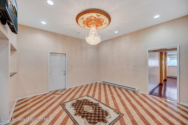 empty room with a notable chandelier and baseboard heating