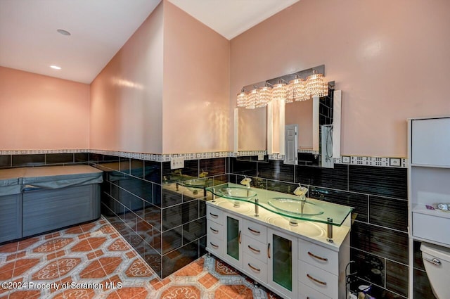 bathroom featuring tile patterned flooring, vanity, tile walls, and toilet