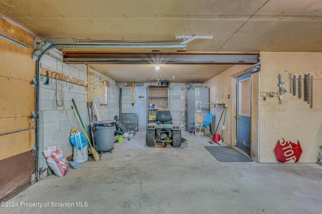 garage with fridge and concrete block wall