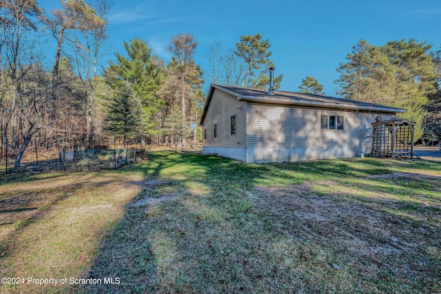 view of side of property with a yard