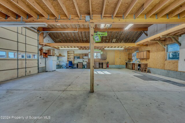 garage with freestanding refrigerator