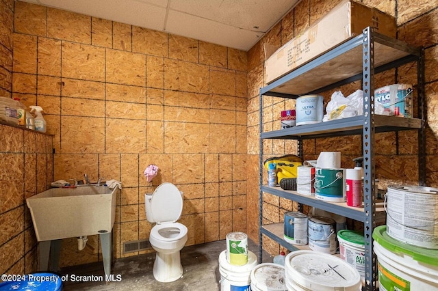 bathroom with a paneled ceiling and sink