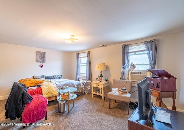 bedroom with carpet floors, multiple windows, and cooling unit