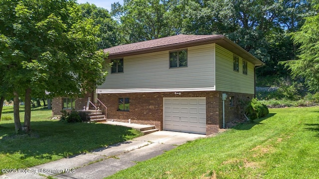 1103 Quarry Rd, Old Forge, PA 18518 - view of front facade featuring concrete driveway, a front yard, a garage, and brick siding