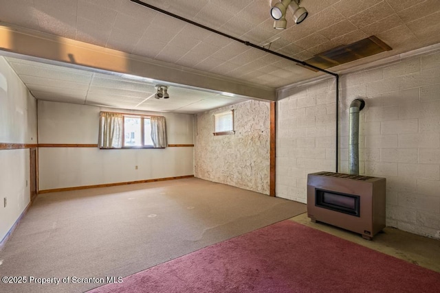 1103 Quarry Rd, Old Forge, PA 18518 - basement featuring heating unit, a wood stove, and carpet