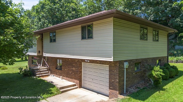 1103 Quarry Rd, Old Forge, PA 18518 - view of side of home featuring an attached garage, a yard, concrete driveway, and brick siding