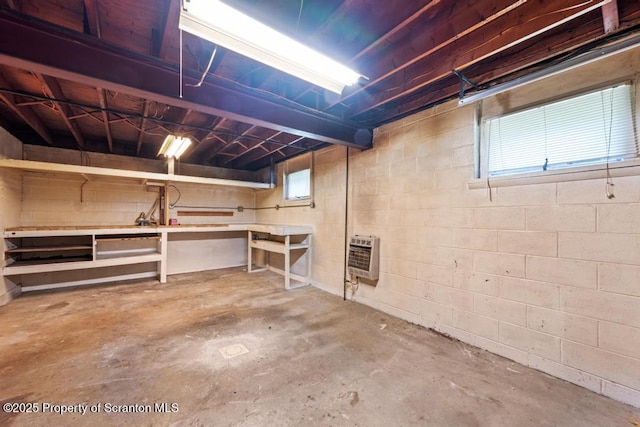 1103 Quarry Rd, Old Forge, PA 18518 - basement featuring heating unit, a workshop area, and concrete block wall