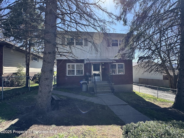 418 Pear St, Scranton, PA 18505 - view of front facade featuring brick siding and fence