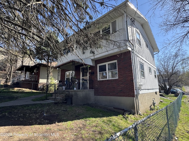 418 Pear St, Scranton, PA 18505 - view of front of home featuring brick siding, a front lawn, and fence