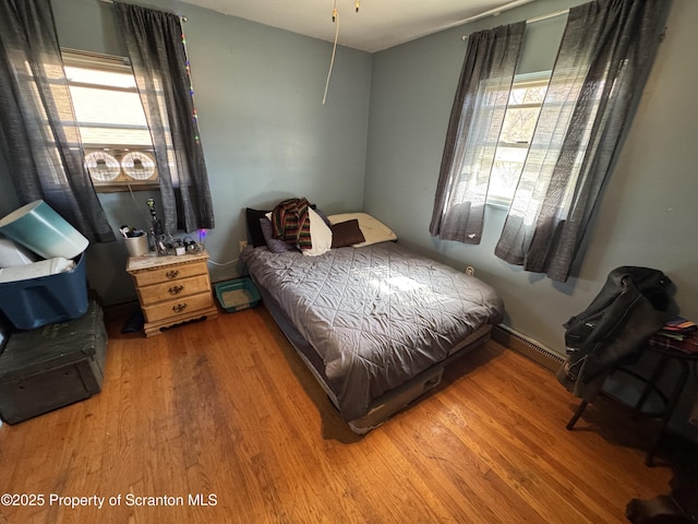 418 Pear St, Scranton, PA 18505 - bedroom featuring a baseboard heating unit and light wood finished floors