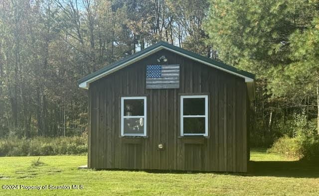 view of outdoor structure featuring a lawn