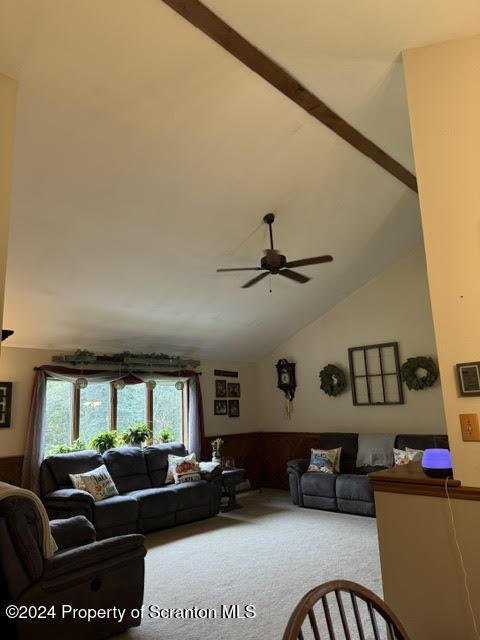 3365 Lake Of Meadows Rd, Little Meadows, PA 18830 - living area featuring carpet flooring, a ceiling fan, a wainscoted wall, and vaulted ceiling