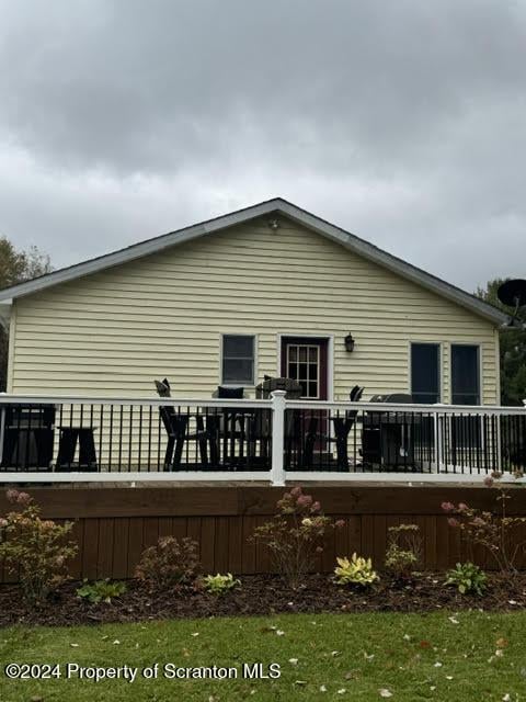 back of house with a wooden deck