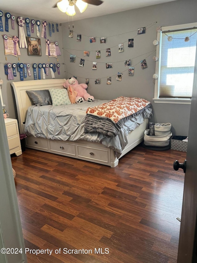 bedroom with ceiling fan and dark hardwood / wood-style floors